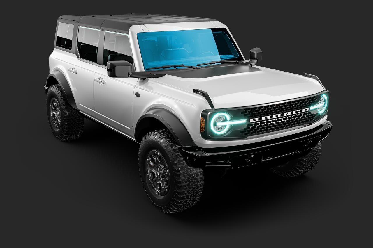 White Ford Bronco SUV with black accents, on a black surface.