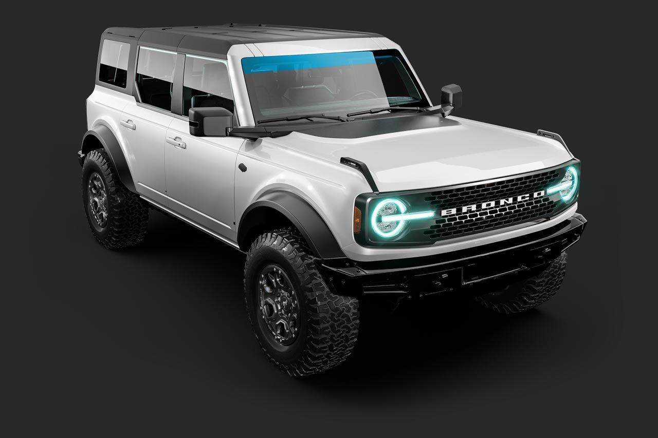 White Ford Bronco SUV on a dark background, with black accents and off-road tires.