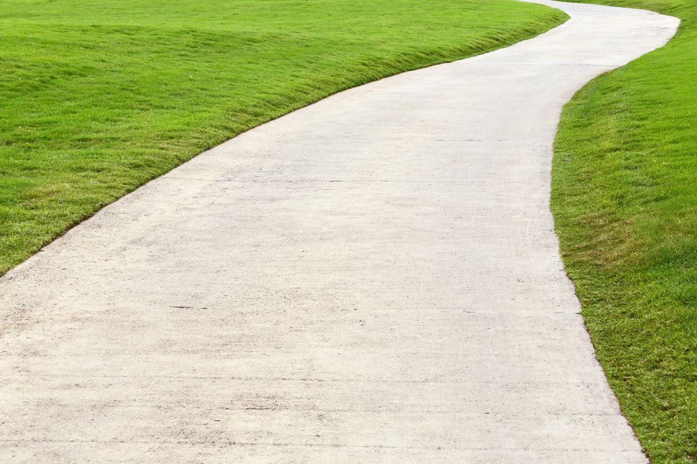 Concrete Path Winds Through Bright Green Grass — Atherton Tableland Concreting in Yungaburra, QLD