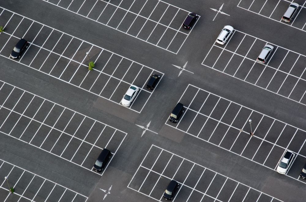 Aerial View of a Parking Lot With Cars Parked in Marked Spaces — Atherton Tableland Concreting in Yungaburra, QLD