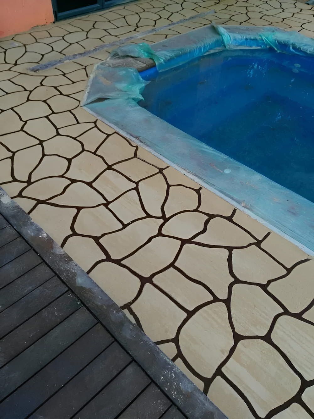 A Swimming Pool is Surrounded by a Wooden Deck — Atherton Tableland Concreting in Yungaburra, QLD