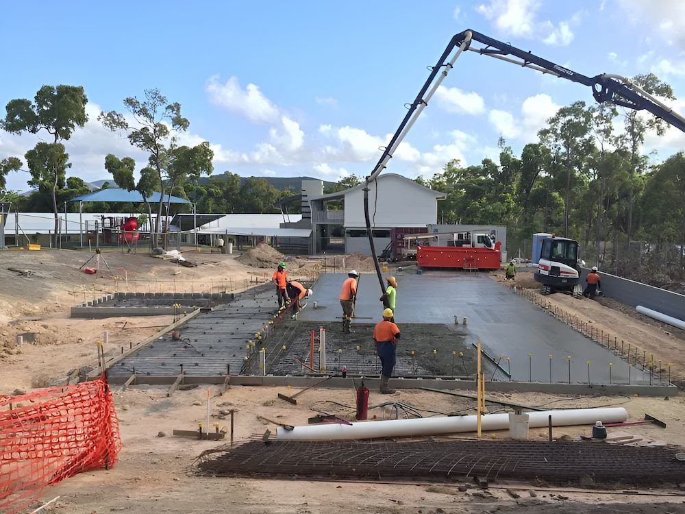 A Group of Construction Workers Are Working on a Concrete Floor — Atherton Tableland Concreting in Yungaburra, QLD