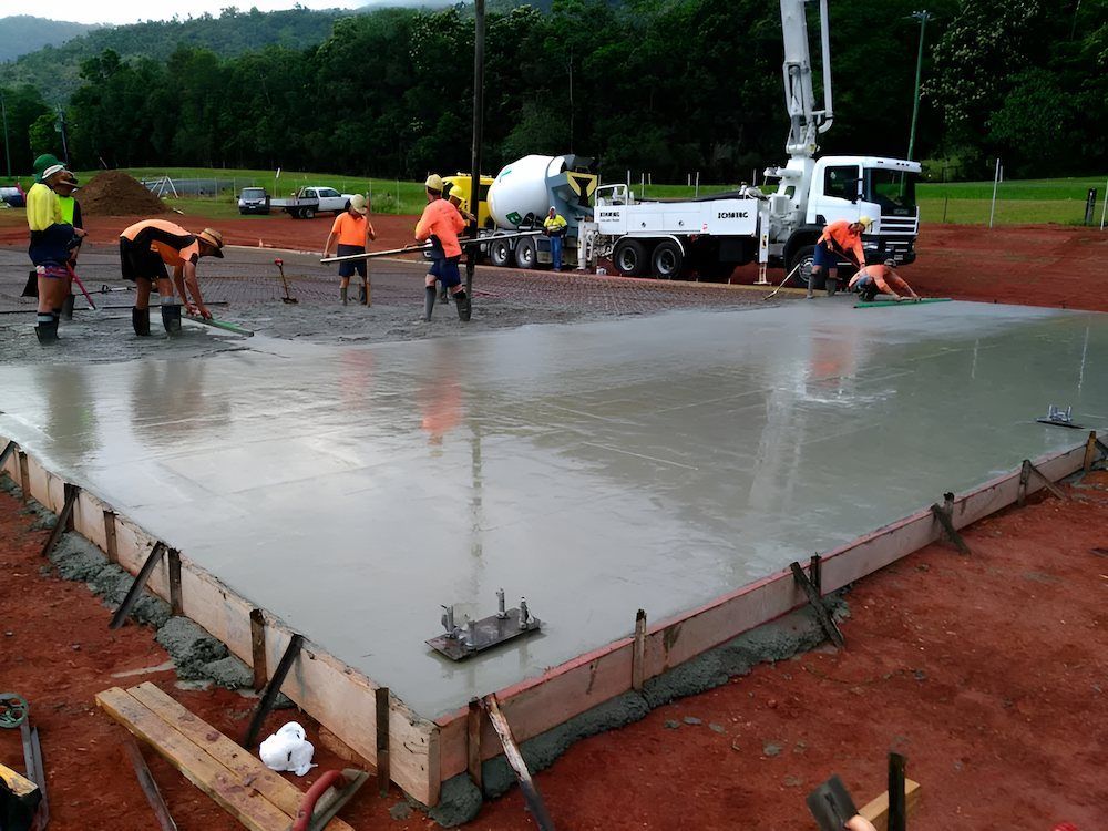 A Group of Construction Workers Are Working on a Concrete Floor — Atherton Tableland Concreting in Yungaburra, QLD
