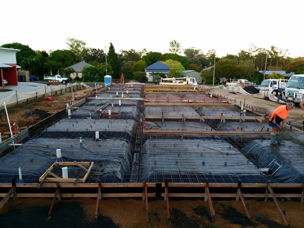 A Construction Site With a Lot of Concrete Being Poured — Atherton Tableland Concreting in Yungaburra, QLD