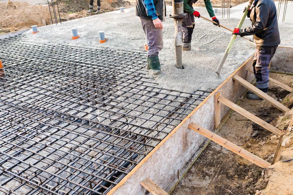 A Group of Construction Workers Are Working on a Concrete Base — Atherton Tableland Concreting in Yungaburra, QLD