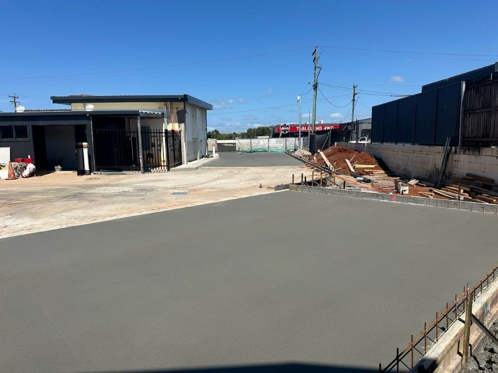 A Concrete Driveway is Being Built in Front of a Building — Atherton Tableland Concreting in Yungaburra, QLD