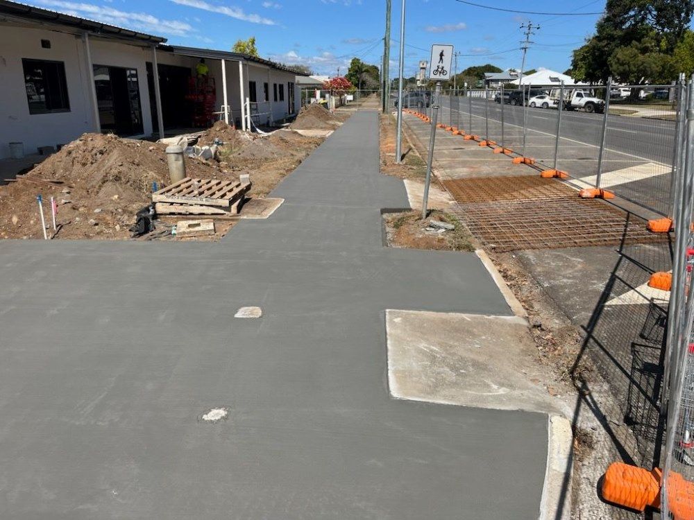 A Concrete Walkway is Being Built in Front of a Building — Atherton Tableland Concreting in Yungaburra, QLD