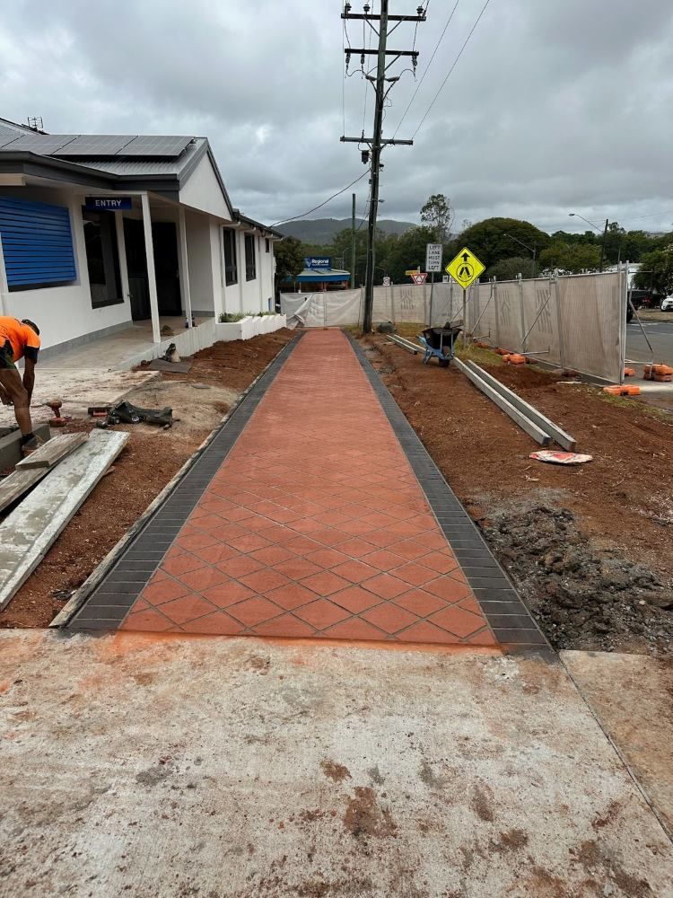 A Concrete Walkway is Being Built in Front of a Building — Atherton Tableland Concreting in Yungaburra, QLD