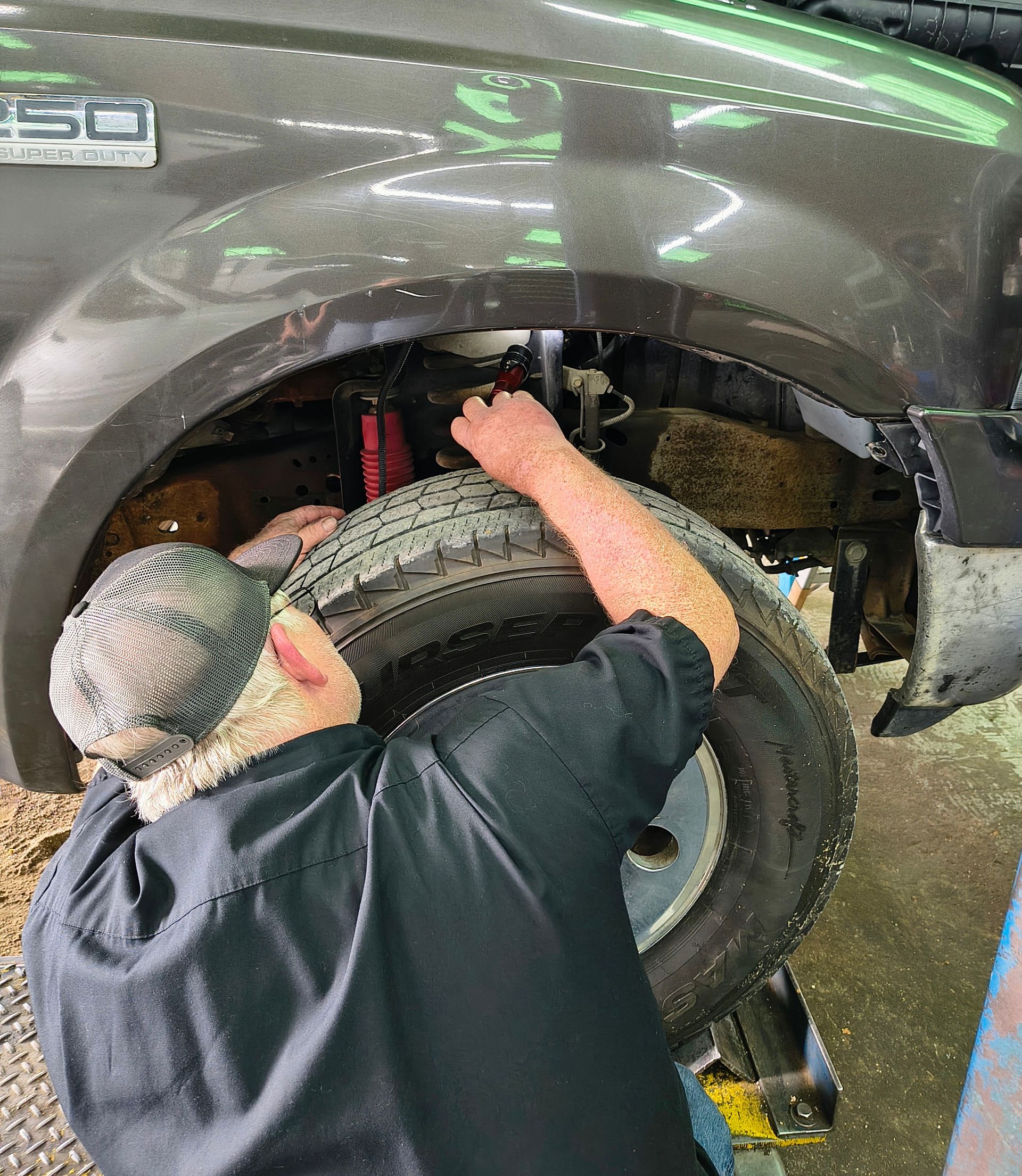 Close-up of a car brake rotor and caliper during vehicle maintenance