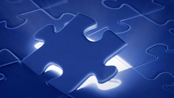 A blue puzzle with a light coming out of it.