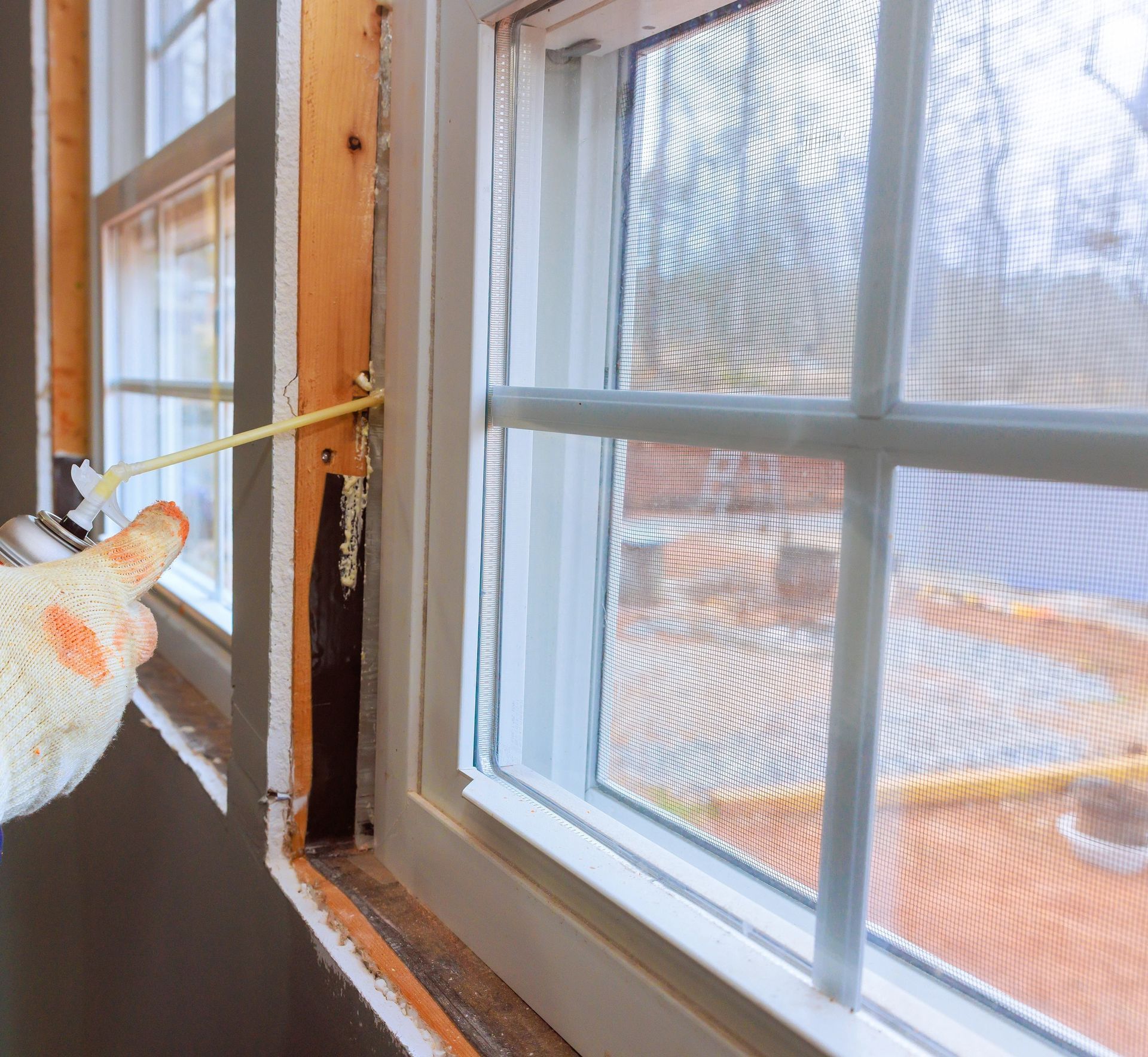 Foam insulation being injected into a window cavity in a Cheyenne, WY residence to help block drafts and reduce heat loss.