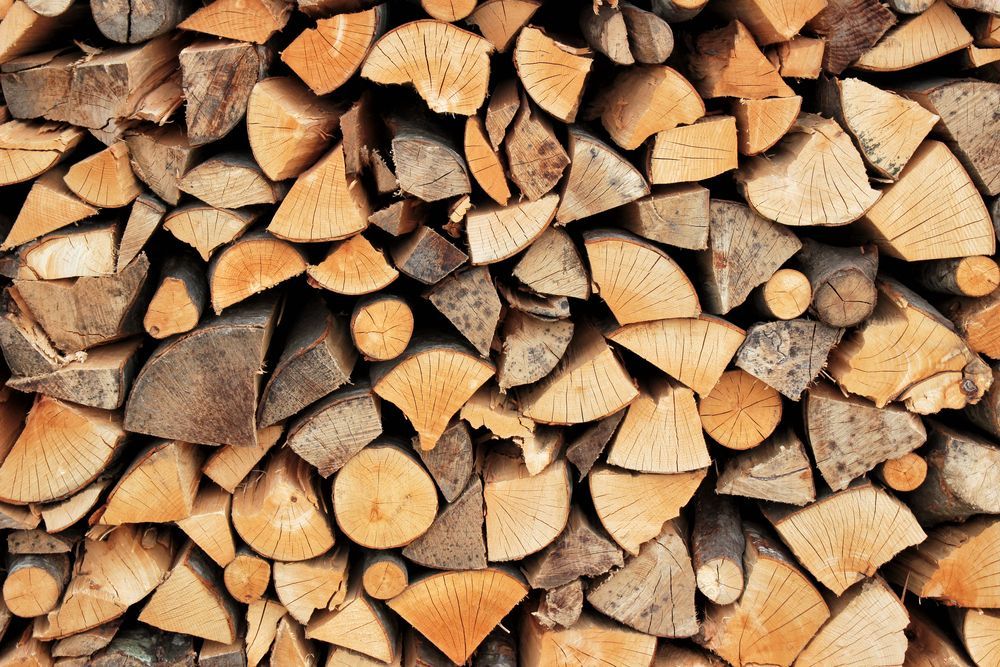 A Pile of Chopped Wood is Stacked on Top of Each Other — Dubbo Soils & Landscaping Supplies in Trangie, NSW
