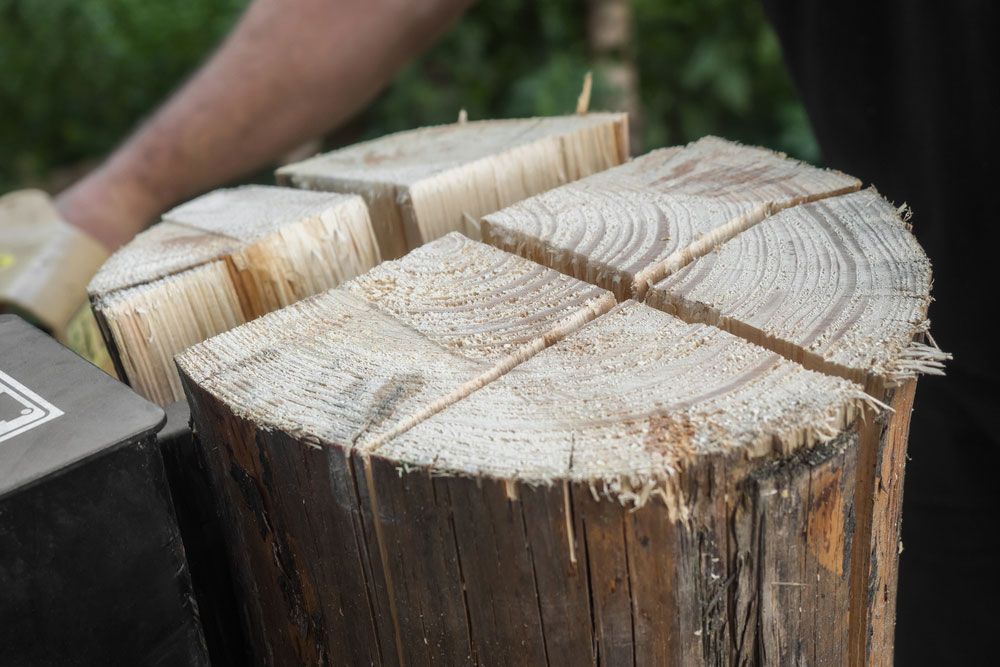 Firewood Split With Wooden Splitter — Dubbo Soils & Landscaping Supplies in Dubbo, NSW