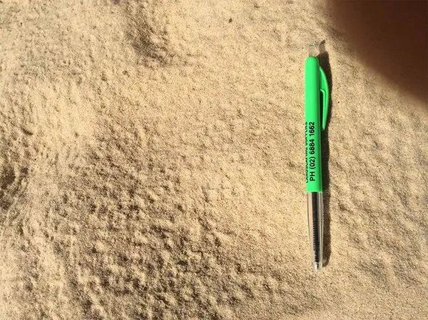 Green Pen Laying on Sand — Dubbo Soils & Landscaping Supplies in Dubbo, NSW