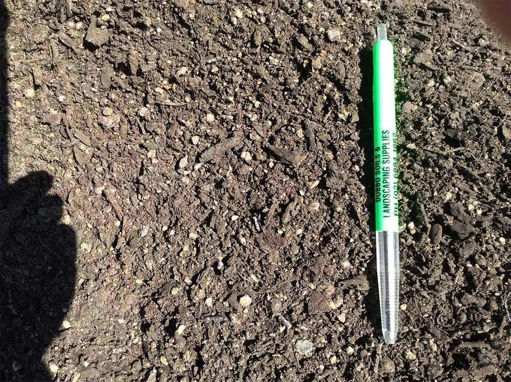 Green Pen Laying on Soil — Dubbo Soils & Landscaping Supplies in Dubbo, NSW