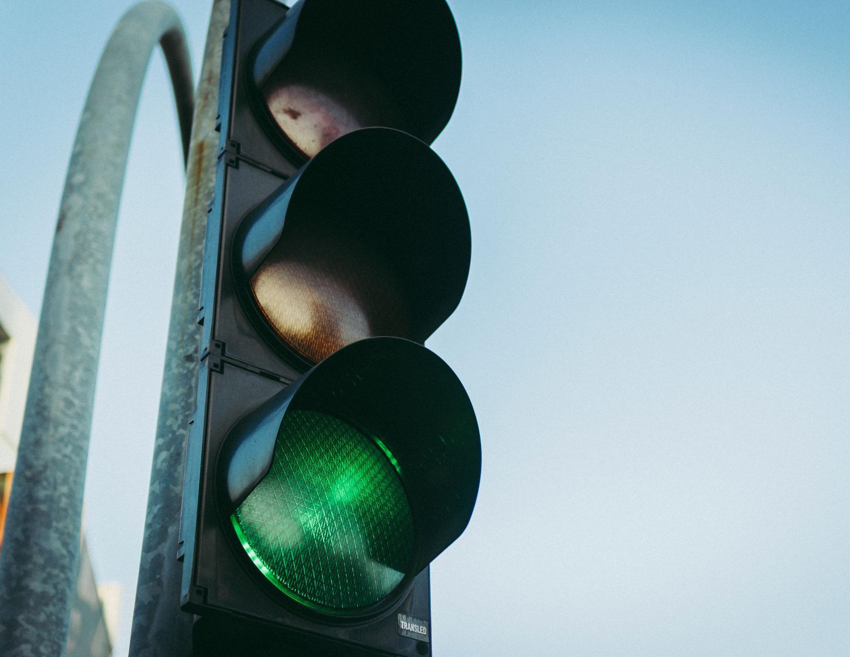 A close up of a traffic light with the green light on