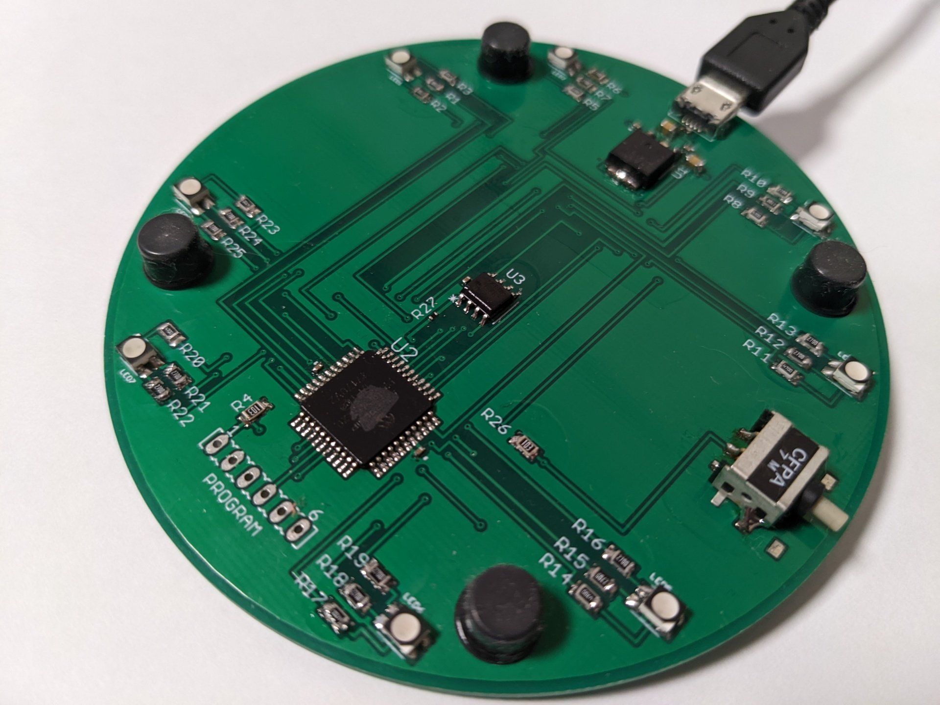 A green circuit board with a usb cable attached to it