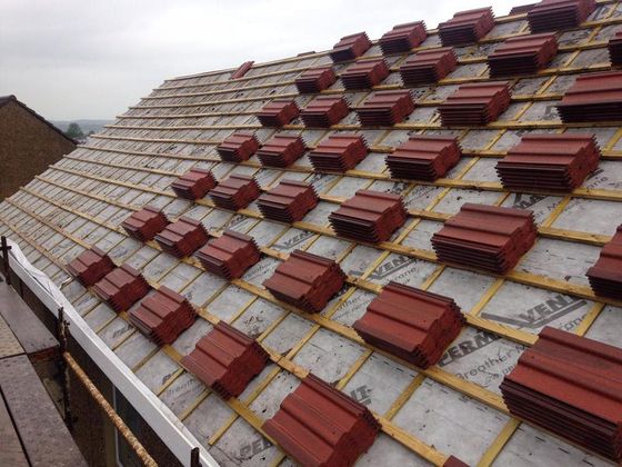 A picture of a itched roof replacement being carried out by KMC Roofers London.