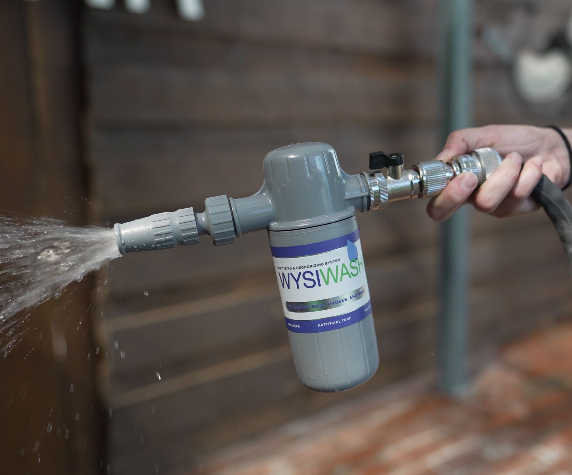 A person is spraying water from a hose.