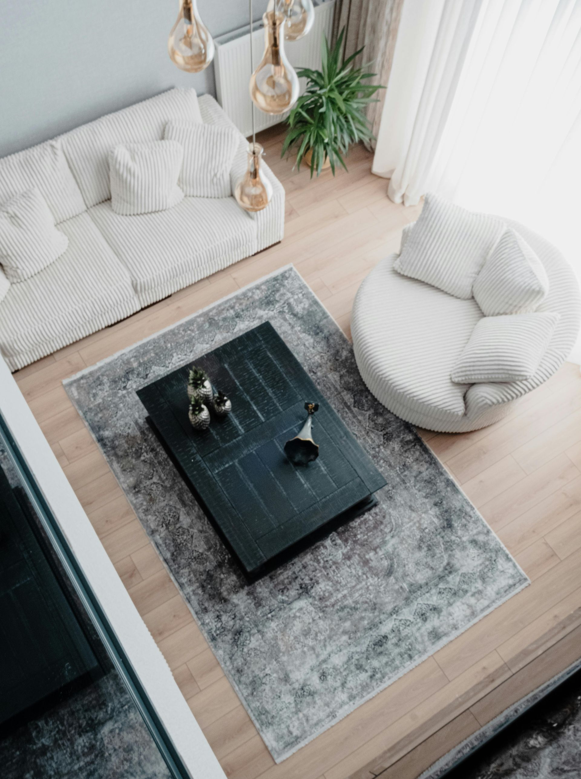 Cozy living room with gray sofa, beanbag chair, and dark coffee table on a light rug