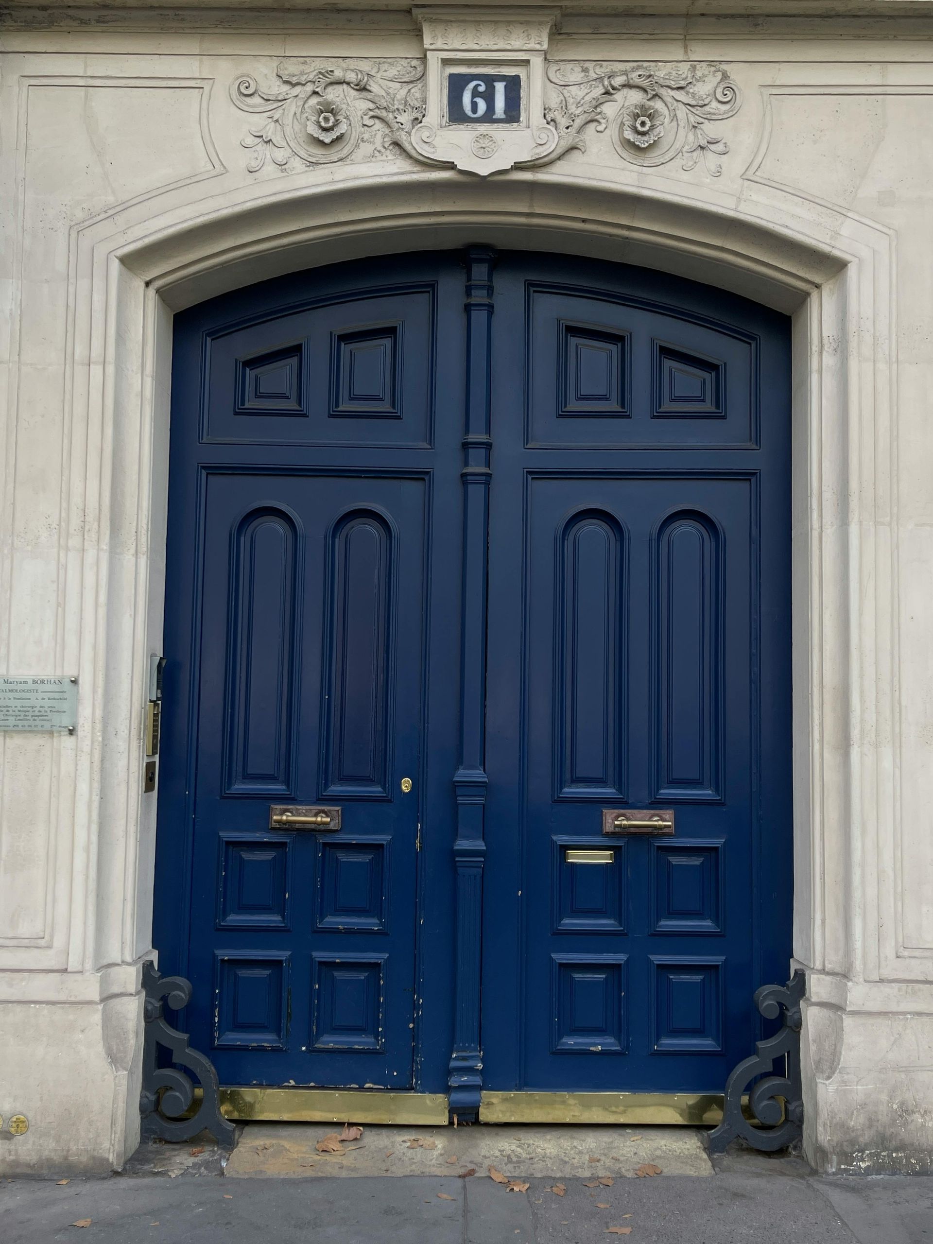 Blue double doors with ornate stone surround, 
