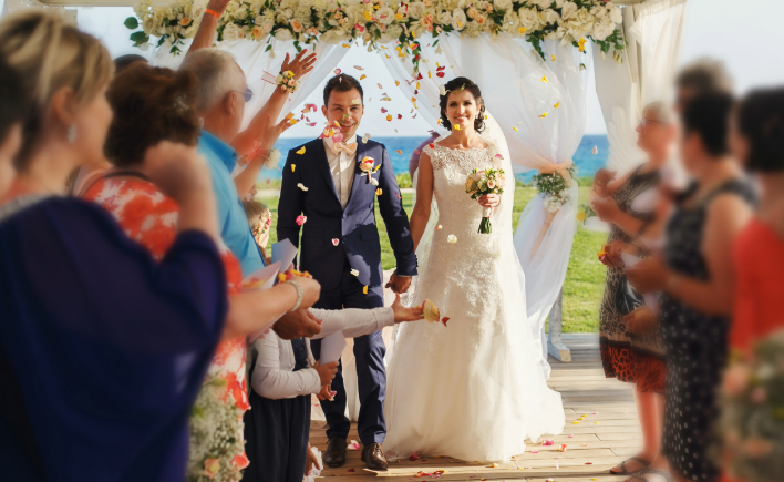 Newlyweds celebrating as guests cheer around them