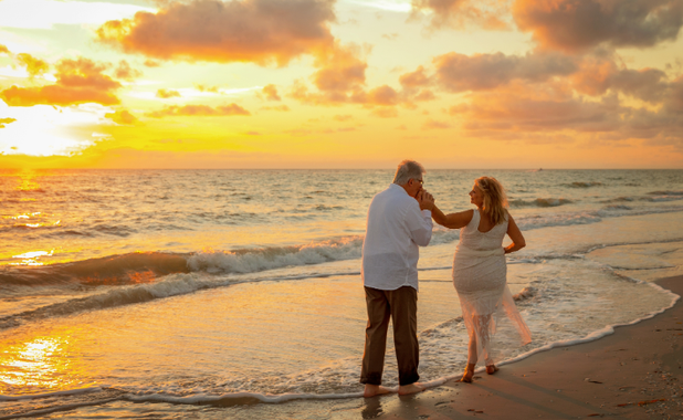 Couple dancing on the beach at sunset
