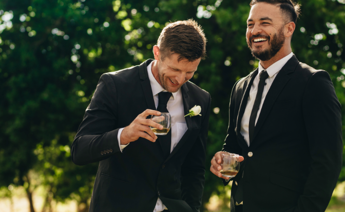Groomsmen laughing together at a wedding
