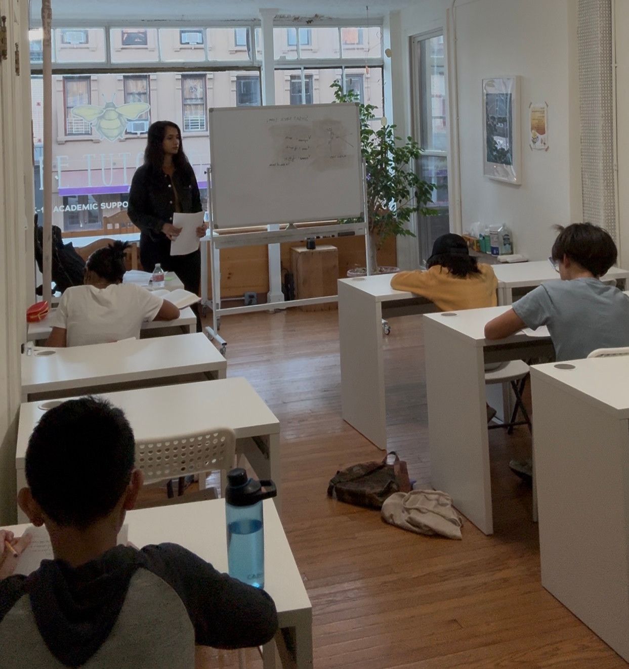 A tutor guiding students through a classroom lesson