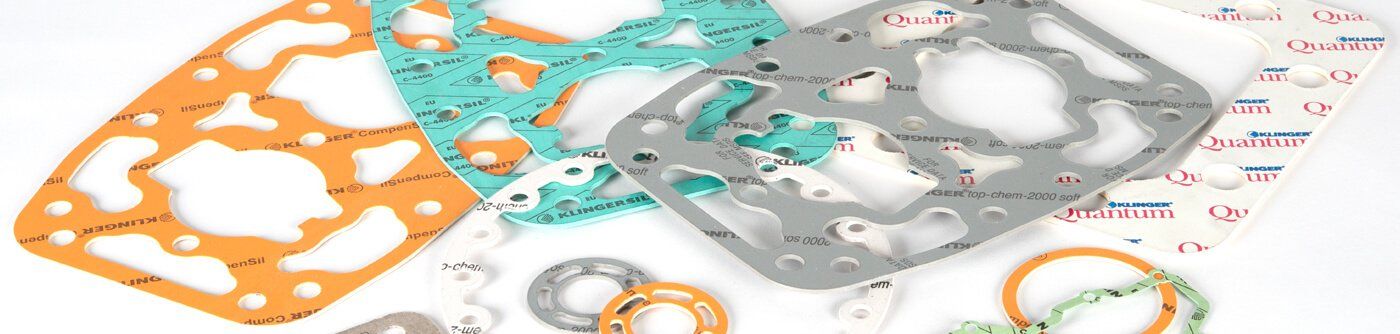People holding KLINGERSIL cut gaskets