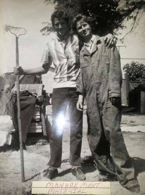 Two people posing. Man holds rake, woman in jumpsuit. Outdoors, text reads 