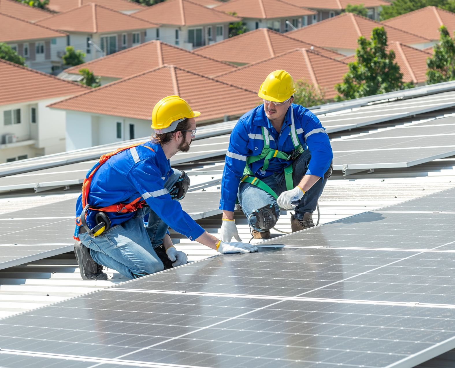 A roofing contractor is installing a metal roof on a house. A roofing contractor is installing a metal roof on a house.