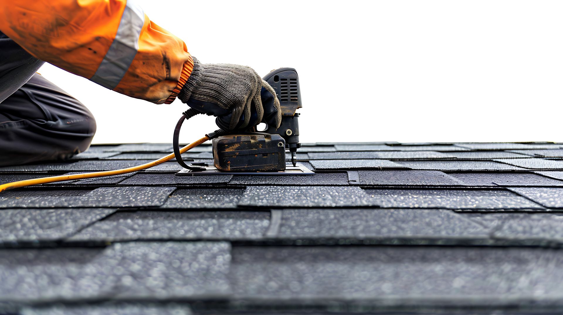 A professional roofing contractor carefully using an air nail gun to place new asphalt bitumen shingles on a home's roof. A professional roofing contractor carefully using an air nail gun to place new asphalt bitumen shingles on a home's roof.