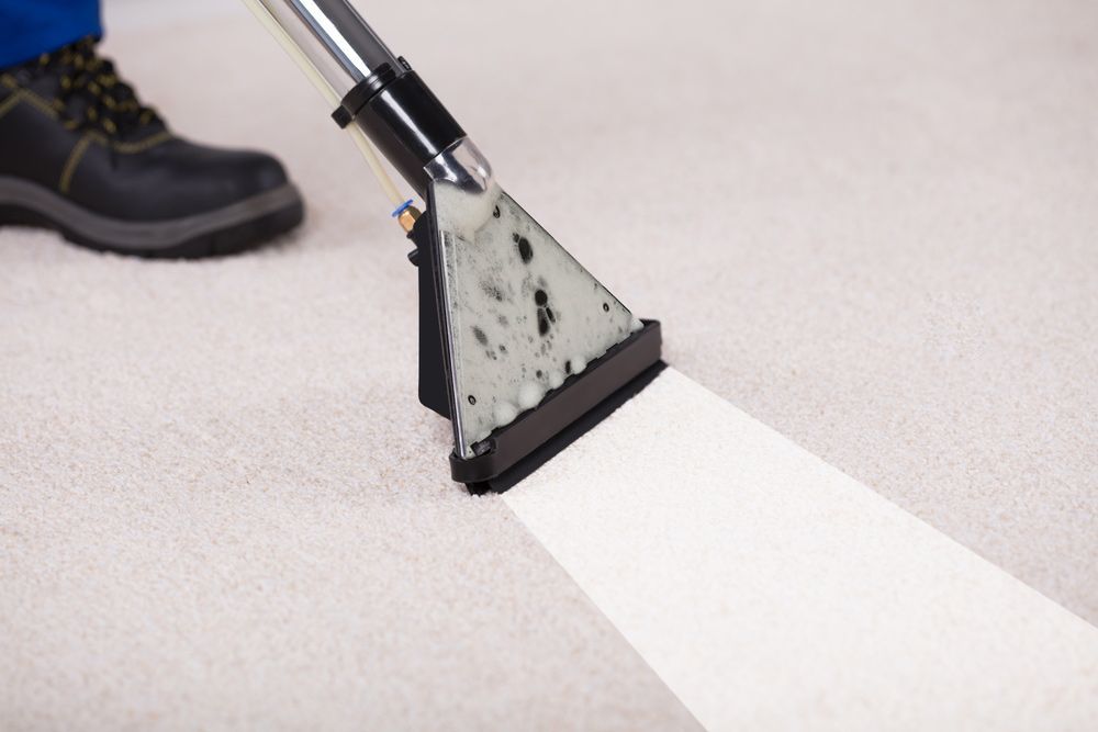 A Person Using Vacuum Cleaner for Floor Cleaning — Big Red Carpet & Property Maintenance In Bowen, QLD