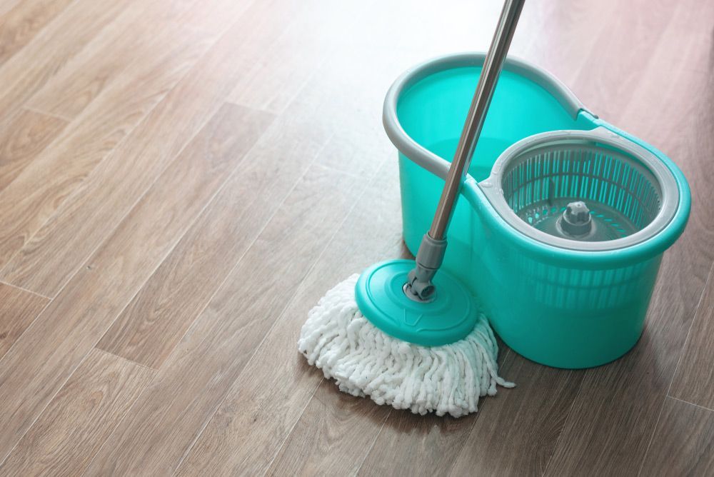 Home Wet Cleaning Concept Background And Bucket With A Mop On A Floor — Big Red Carpet & Property Maintenance In Bowen, QLD