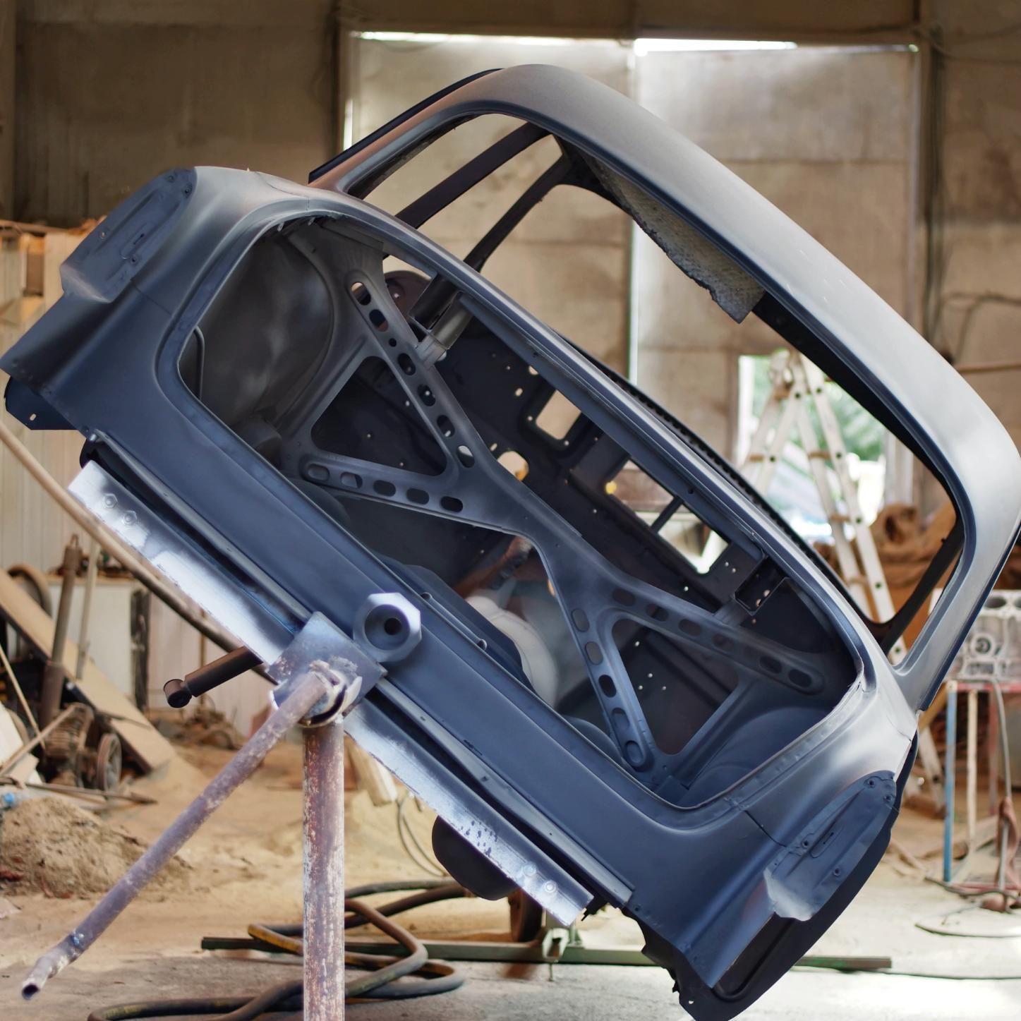 A car is sitting on a stand in a garage.