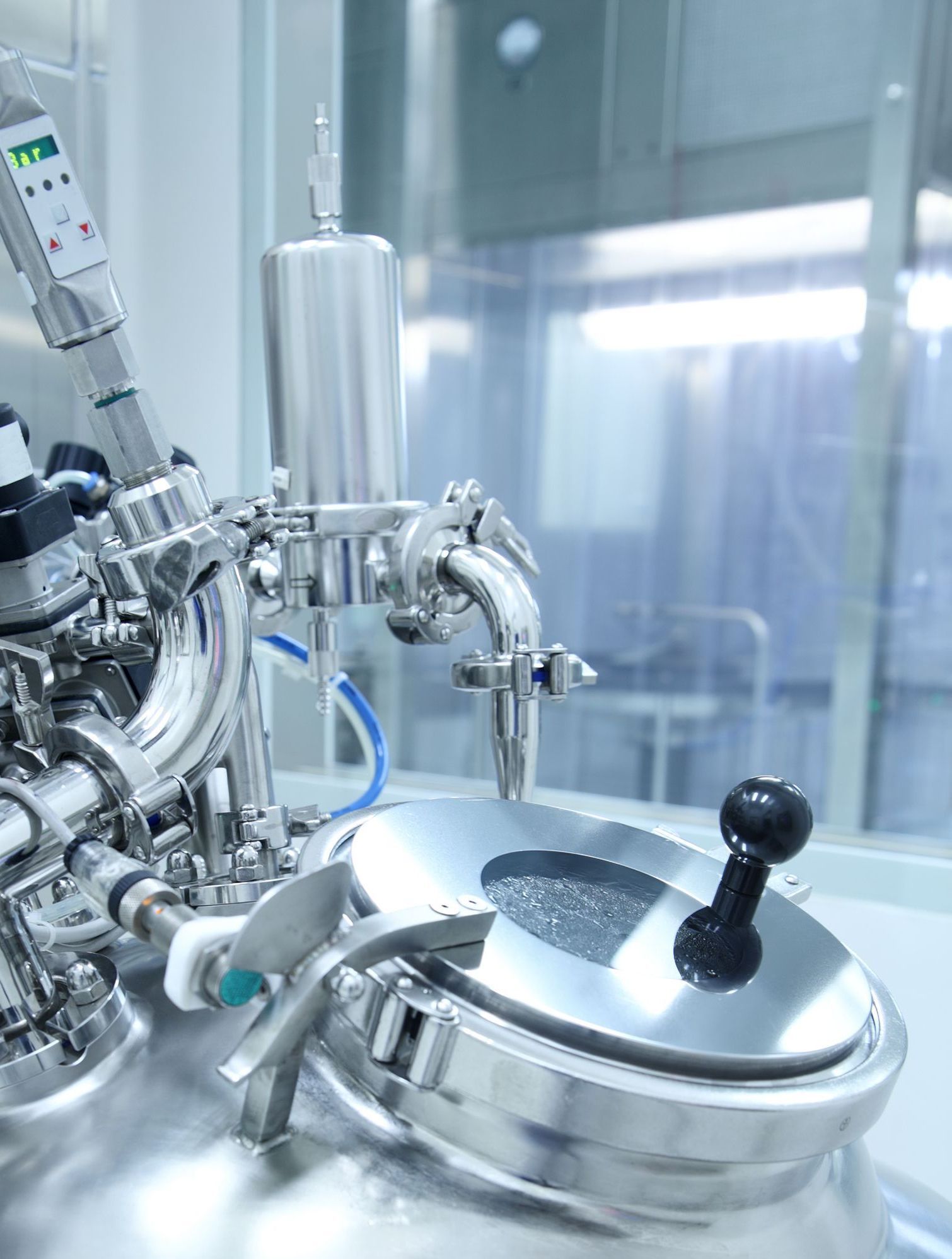 A close up of a stainless steel machine in a laboratory.