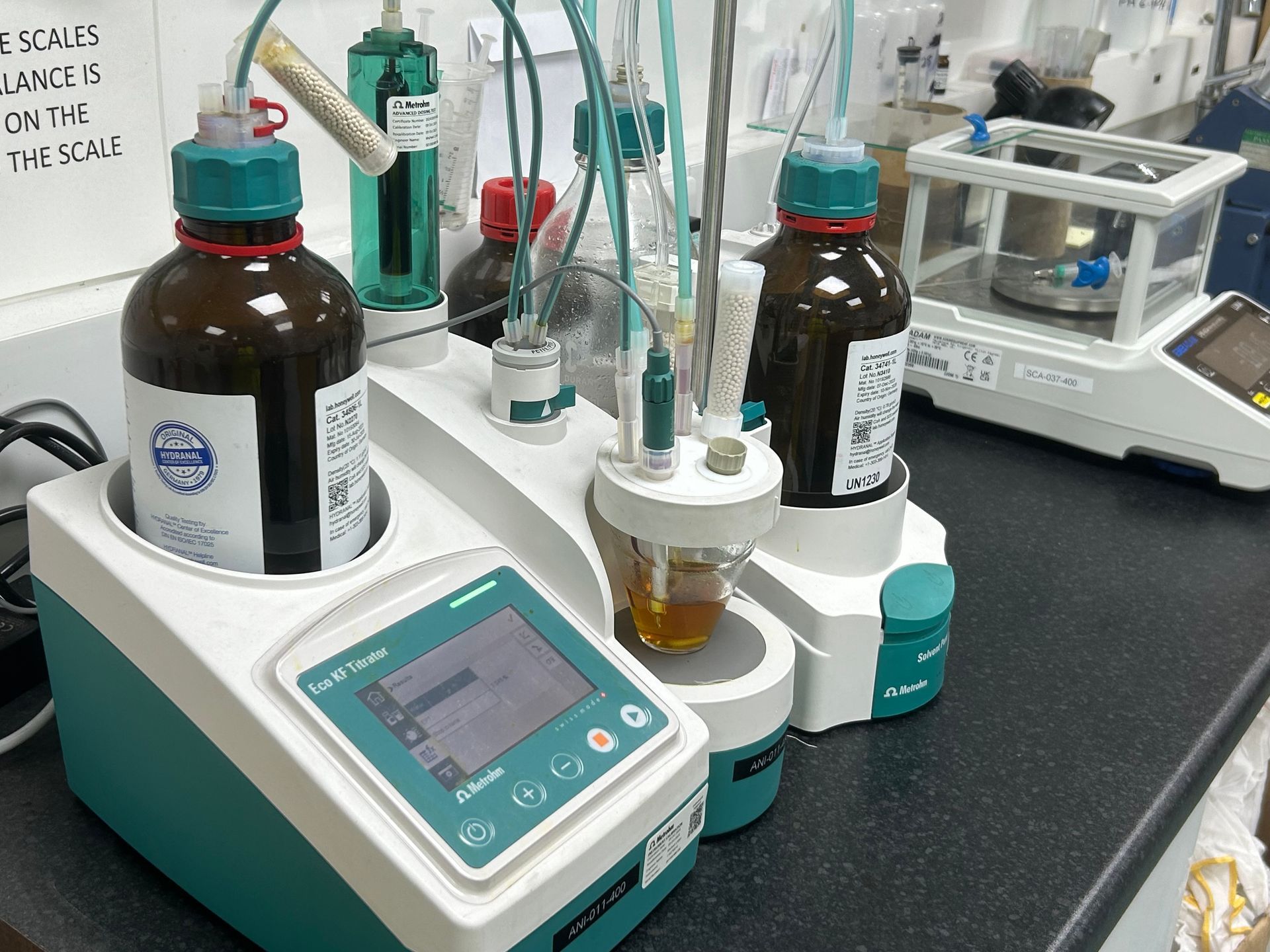 A laboratory with bottles and a scale on the counter