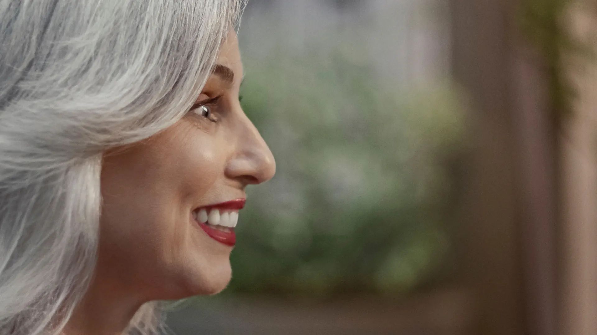 Person comfortably wearing a Signia MaX hearing aid indoors