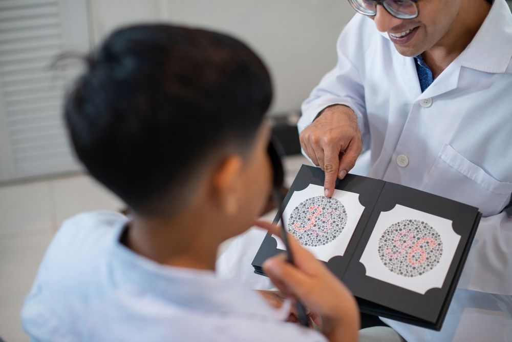 A Doctor Is Giving a Child a Test to See if He Has Color Blindness — New Look Eyewear In Maitland, NSW