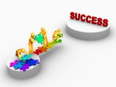 Tiny figures place puzzle pieces toward a red “SUCCESS” on white platforms.