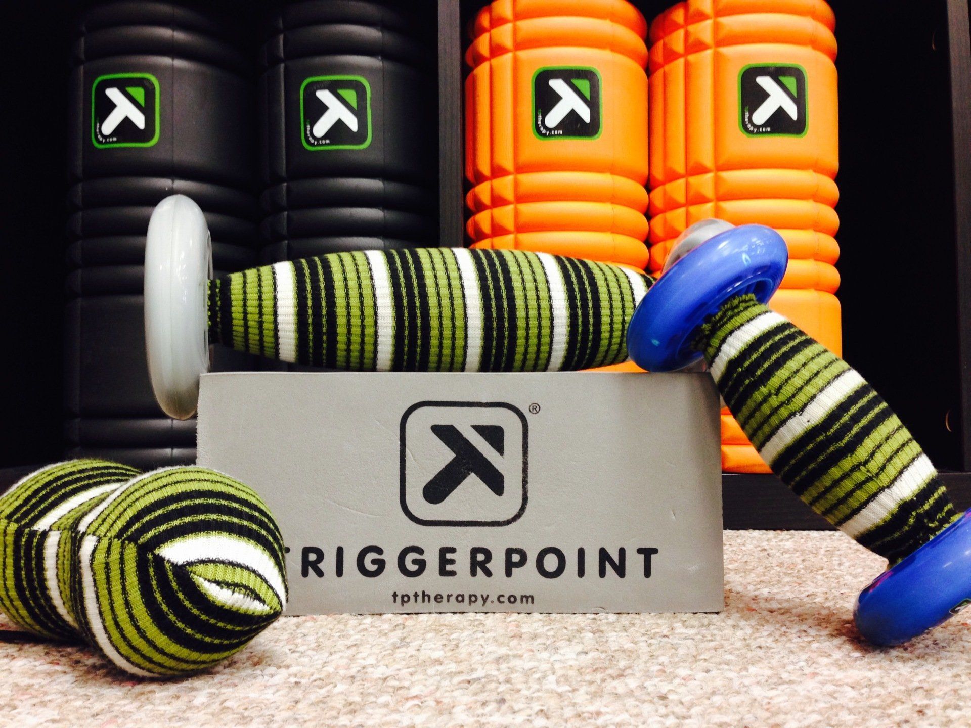 Triggerpoint climbing ropes and gear with black, orange, green, and blue coils around a box logo