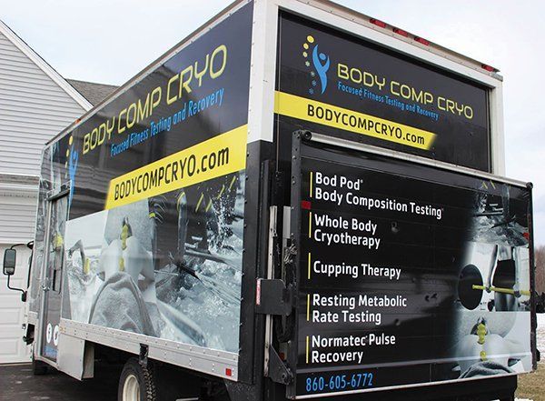 Trailer for Body Comp Cryo with black-and-yellow branding and wellness treatment list.
