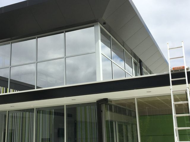 A Building With A Lot Of Windows And A Ladder On The Side – Adelaide, SA - Sola Bloc Window Tinting
