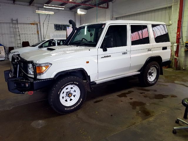 A White Toyota Land Cruiser Is Parked In A Garage – Adelaide, SA - Sola Bloc Window Tinting