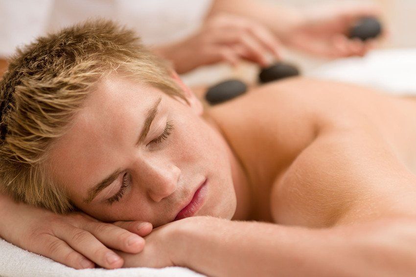 man having hot stone massage