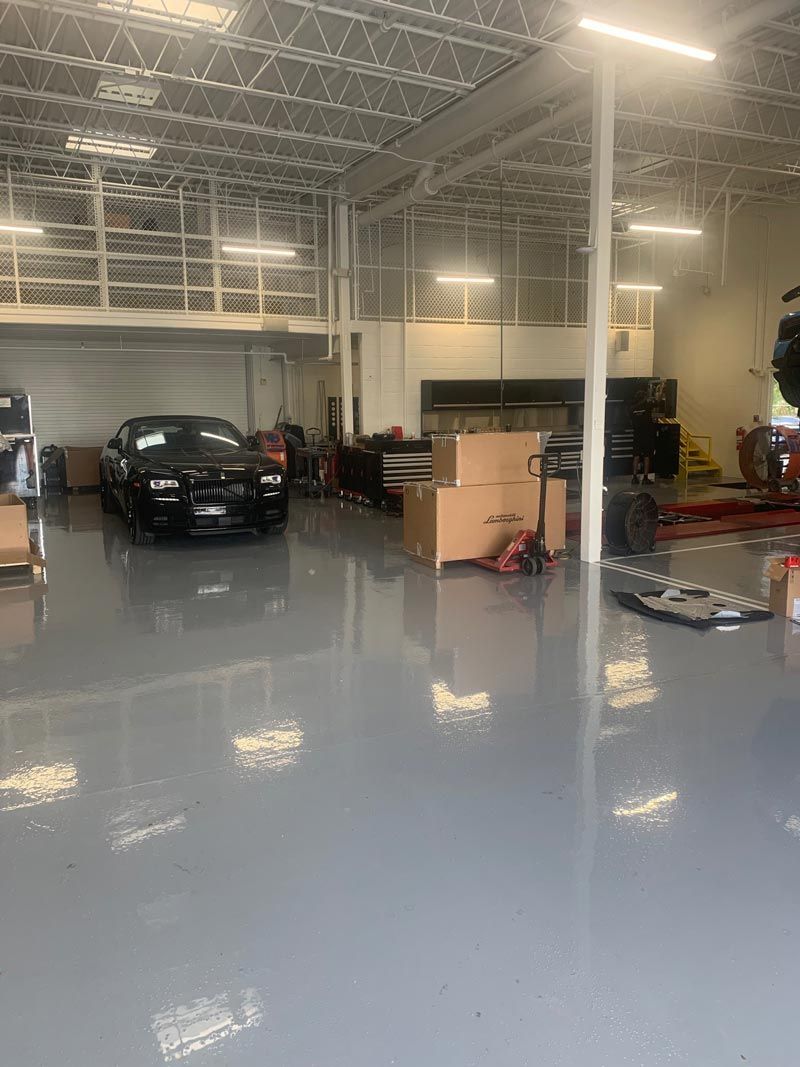 Black Car In Repair Shop — Debary, FL — All American Epoxy Flooring LLC
