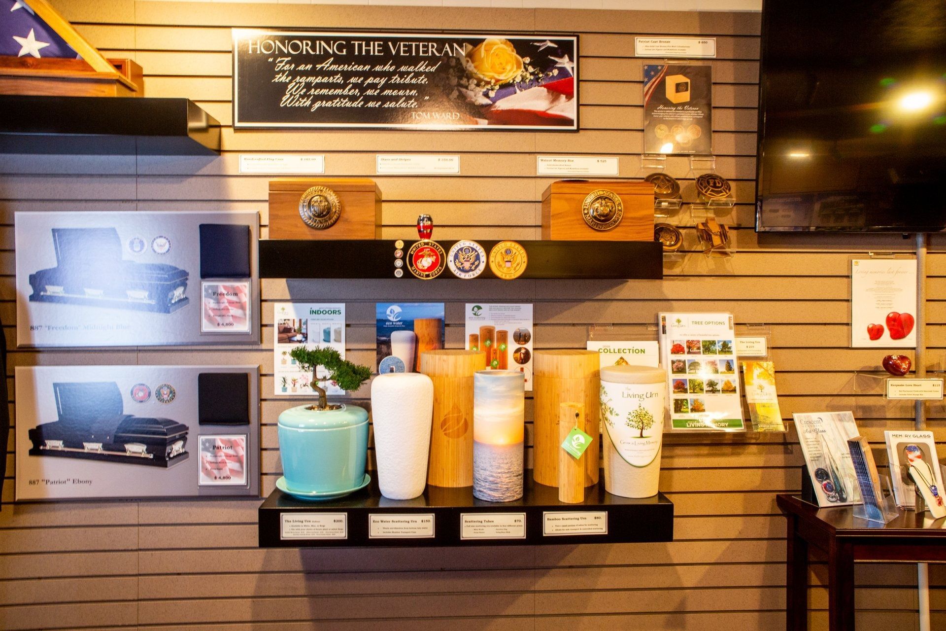 Store display of colorful candles, soaps, and signs on a slat-wall shelf.