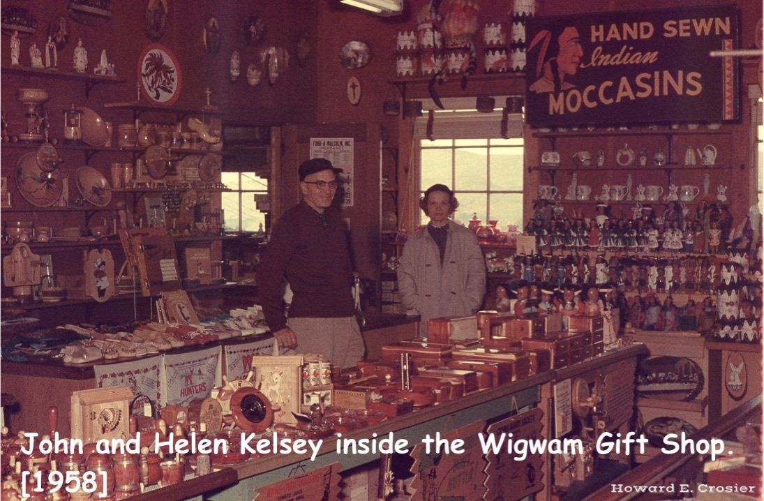 John and Helen Kelsey stand in their Wigwam Gift Shop filled with shelves of merchandise and moccasin signs in 1958.