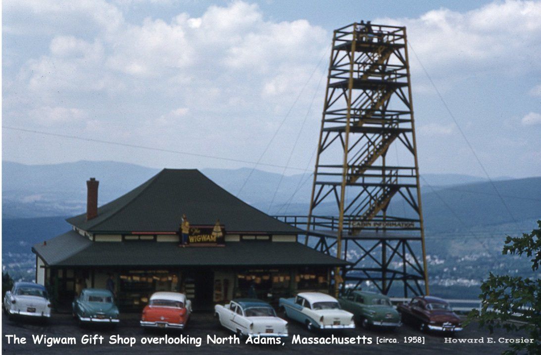 The Wigwam Gift Shop with a tall observation tower in North Adams, Massachusetts, circa 1957, with vintage cars parked.